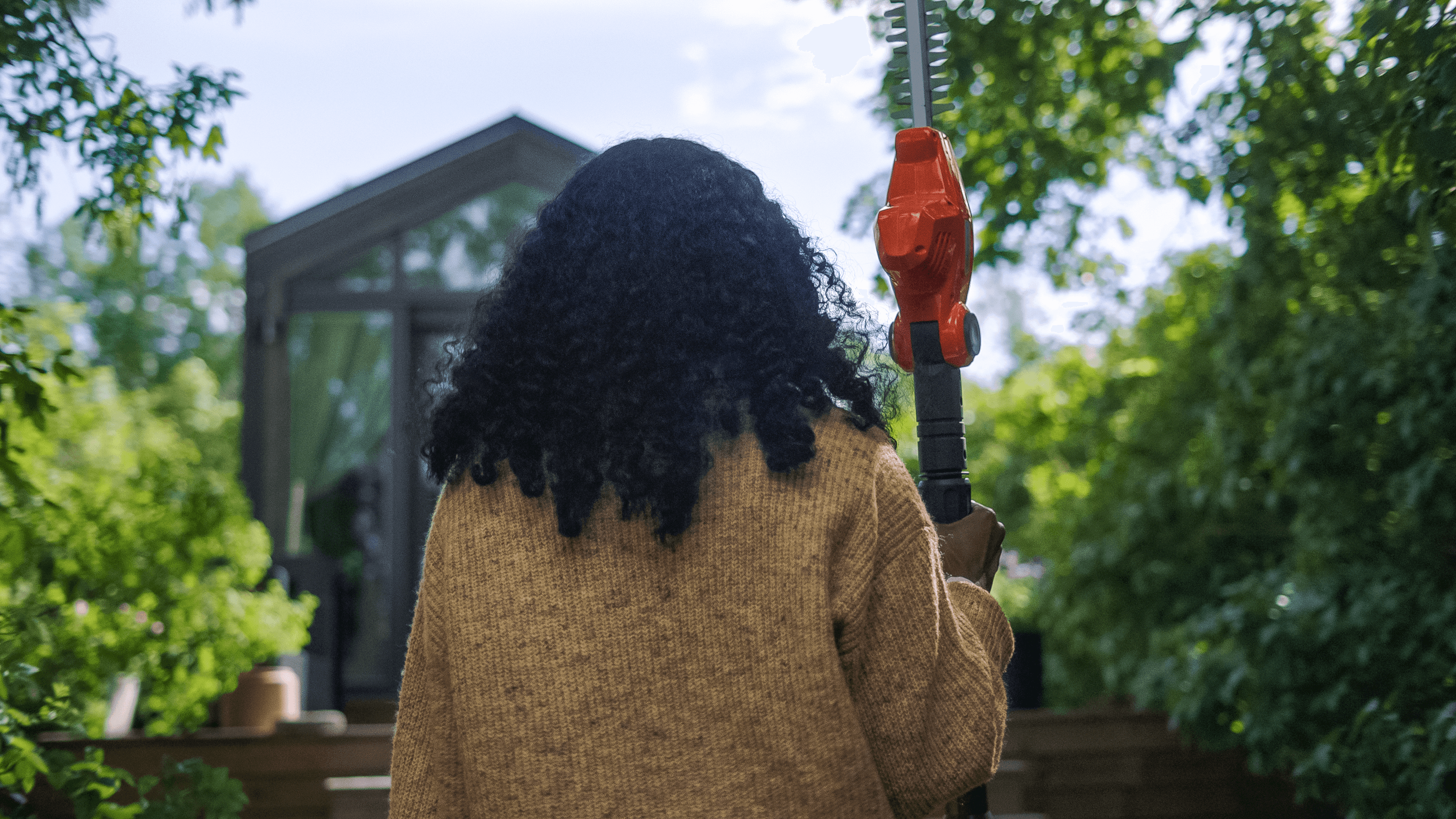 man holding chainsaw whilst cutting tree